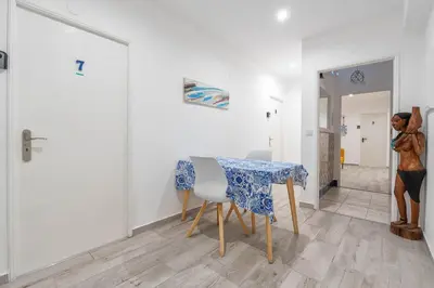 a dining room with a table and a statue of a woman at Blife Antonya private rooms at 3rd floor in Faro