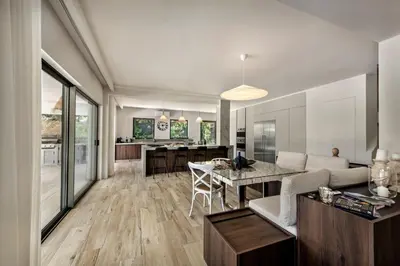 a kitchen and living room with a couch and a table at Dazzling Almancil Villa Villa Magorian 4 Bedrooms Spacious Furnished in Almancil