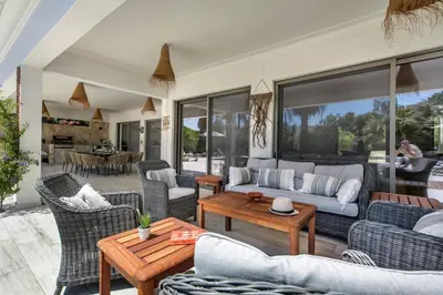 a living room with a couch and chairs and a table at Dazzling Almancil Villa Villa Magorian 4 Bedrooms Spacious Furnished in Almancil