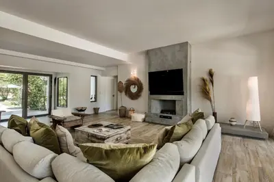 a living room with a white couch and a fireplace at Dazzling Almancil Villa Villa Magorian 4 Bedrooms Spacious Furnished in Almancil