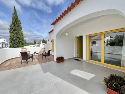 a patio of a house with a table and chairs at Vilamoura Club Villa 3 With Pool by Homing in Vilamoura