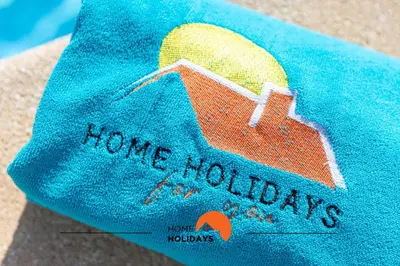 a towel with a picture of a house on it at #243 Jardins de Santa Eulália H23 by Home Holidays in Albufeira