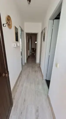 a hallway with white walls and a wooden floor at Apartamento T1 centro Albufeira in Albufeira
