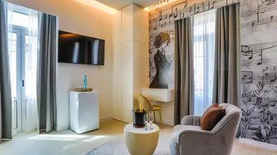 a living room with a chair and a tv at Arts by Loulé - Alojamento de Charme in Loulé