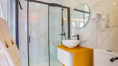 a bathroom with a glass shower and a sink at Arts by Loulé - Alojamento de Charme in Loulé