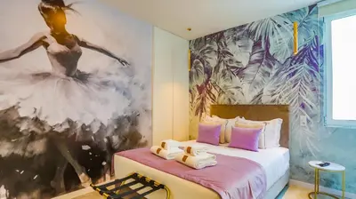 a bedroom with a large painting of a ballet dancer at Arts by Loulé - Alojamento de Charme in Loulé