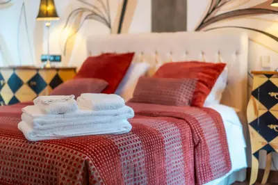 a bed with towels sitting on top of it at Oakmoon House in Faro