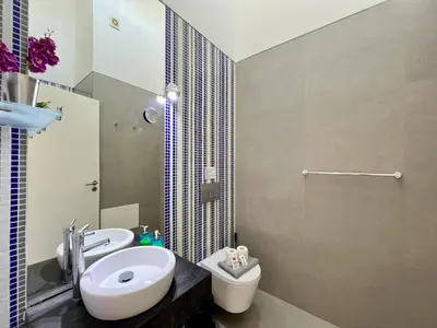 a bathroom with a sink and a toilet and a shower at Vilamoura Club Villa 2 With Pool by Homing in Vilamoura