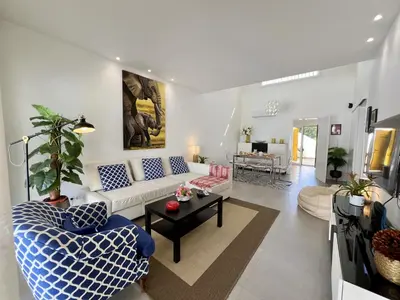 a living room with a couch and a table at Vilamoura Club Villa 2 With Pool by Homing in Vilamoura