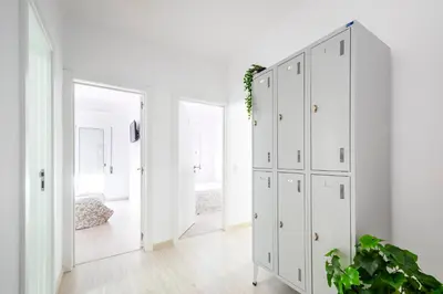 a white wardrobe in a bedroom with a bed at GrowIN Stay Mercado in Faro