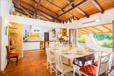 a kitchen with a table and chairs in a room at Villa Alice by Algarve Vacation in Albufeira