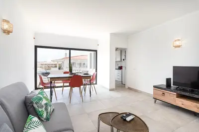 a living room with a couch and a tv and a table at BelChoro SeaLine in Albufeira