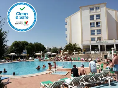 a group of people in the swimming pool at a resort at Ourabay Hotel Apartamento - Art & Holidays in Albufeira