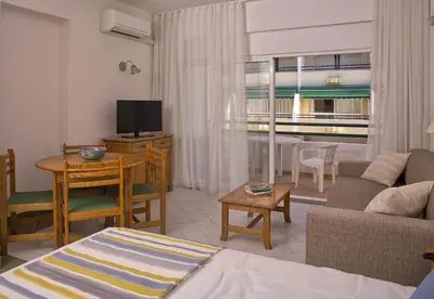 a living room with a couch and a table at Ourabay Hotel Apartamento - Art & Holidays in Albufeira