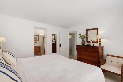 a bedroom with a bed and a dresser and a mirror at Casa Isabella in Vilamoura