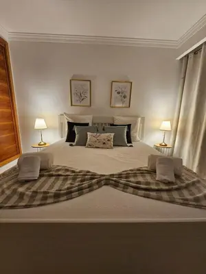 a bedroom with a large bed with two lamps at Colina do Atlântico 203 in Albufeira