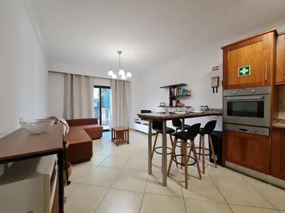 a kitchen and living room with a table and chairs at Colina do Atlântico 203 in Albufeira