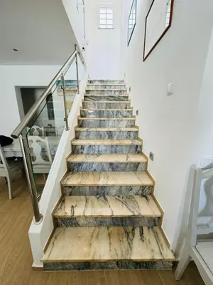 a staircase in a house with wooden floors and white walls at Casa Da Amélia in Albufeira