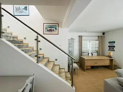 a living room with a staircase and a desk at Casa Da Amélia in Albufeira