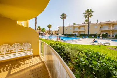 a balcony with a view of the pool at a resort at Jardins Vale de Parra in Albufeira