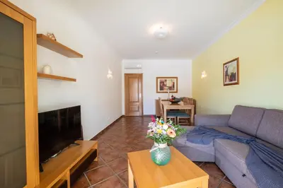 a living room with a couch and a table at Jardins Vale de Parra in Albufeira