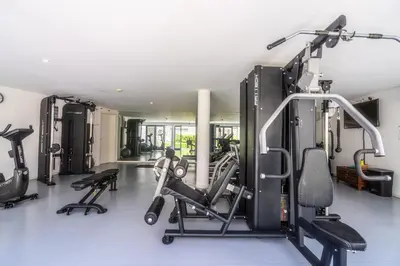 a gym with treadmills and machines in a room at Vilamoura Pine Hills with Pool by Homing in Vilamoura