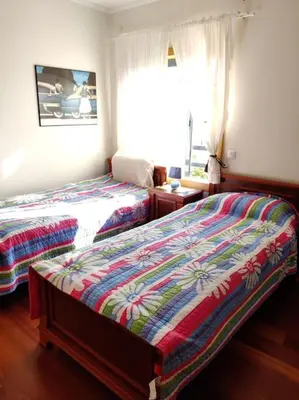 a bedroom with two beds and a window at 2 bedroom top floor apartment in Albufeira in Albufeira