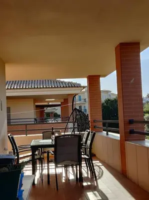 a patio with a table and chairs on a balcony at 2 bedroom top floor apartment in Albufeira in Albufeira