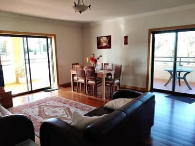 a living room with a couch and a table at 2 bedroom top floor apartment in Albufeira in Albufeira