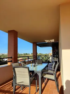 a patio with a table and chairs on a balcony at 2 bedroom top floor apartment in Albufeira in Albufeira