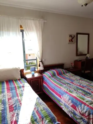 a bedroom with two beds and a window at 2 bedroom top floor apartment in Albufeira in Albufeira
