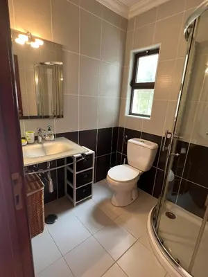 a bathroom with a toilet and a sink and a shower at Apartamento São Rafael Holidays in Albufeira
