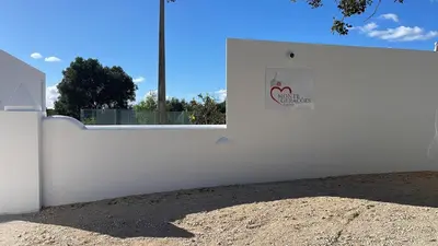 a white fence with a sign on the side of it at Monte Gerações - Complete House - Heated pool - Typical Algarvian - close to Quinta Lago Vale Lobo and Vilamoura in Almancil