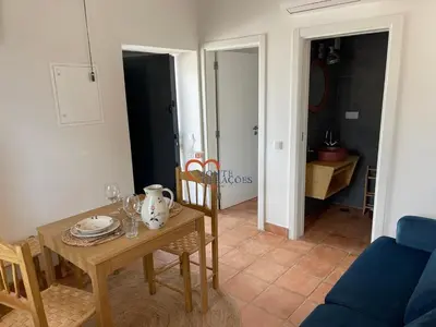 a dining room with a table and a blue couch at Monte Gerações - Complete House - Heated pool - Typical Algarvian - close to Quinta Lago Vale Lobo and Vilamoura in Almancil