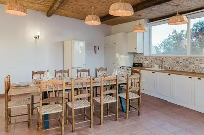 a kitchen with a large wooden table and chairs at Monte Gerações - Complete House - Heated pool - Typical Algarvian - close to Quinta Lago Vale Lobo and Vilamoura in Almancil
