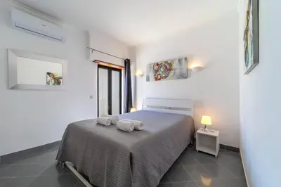 a bedroom with a bed with two towels on it at Garnero Apartment by HelloVacations in Albufeira