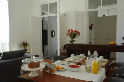 a dining room table with food and drinks on it at Casas Adentro in Faro