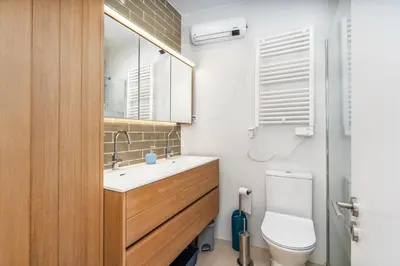 a bathroom with a toilet and a sink and a mirror at Casa da Amélia in Albufeira