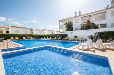 a swimming pool in the middle of a building at Apartamento Bernard in Albufeira