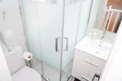a bathroom with a shower and a toilet and a sink at Apartamento Bernard in Albufeira