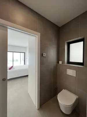 a bathroom with a toilet and a bed at villagoldra rentals - Luxury and Family Villa in Goldra de Baixo