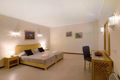 a bedroom with a bed and a table and a chair at Bela Vista House T2 in Albufeira