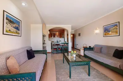 a living room with two couches and a table at Bela Vista House T2 in Albufeira