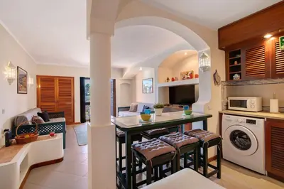 a kitchen with a table and chairs in a room at Bela Vista House T2 in Albufeira