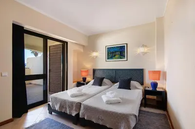 a bedroom with a bed with two towels on it at Bela Vista House T2 in Albufeira