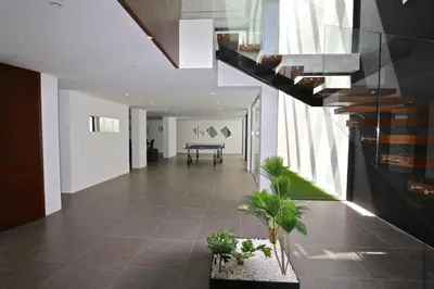 a hallway with a staircase and plants in a building at Villa Pinheiro CD 84 - Cleverdetails in Vilamoura