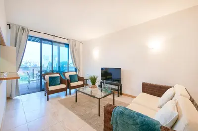 a kitchen with white cabinets and a washer and dryer at Residence Golf Club lovely Ap in Quarteira