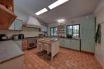 a large kitchen with a island in the middle at Casa Tranquility with beautiful heated pool and Jacuzzi! in Loulé