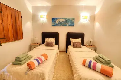 a room with two beds with towels on them at Casa Tranquility with beautiful heated pool and Jacuzzi! in Loulé