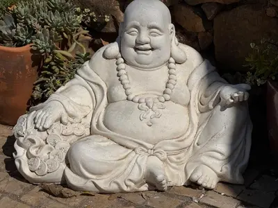 a statue of a monk sitting on the ground at Casa Tranquility with beautiful heated pool and Jacuzzi! in Loulé